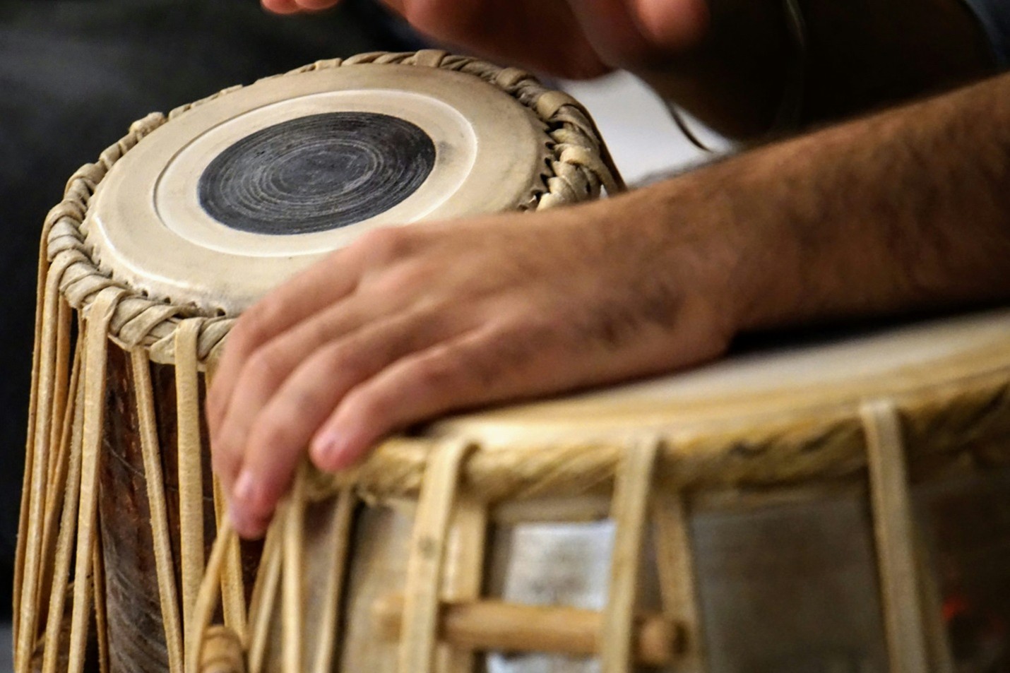 Indian classical musicians performing fusion music with traditional instruments and modern sounds on stage.